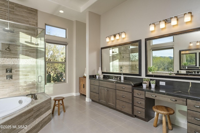 bathroom featuring tile patterned floors, shower with separate bathtub, and vanity