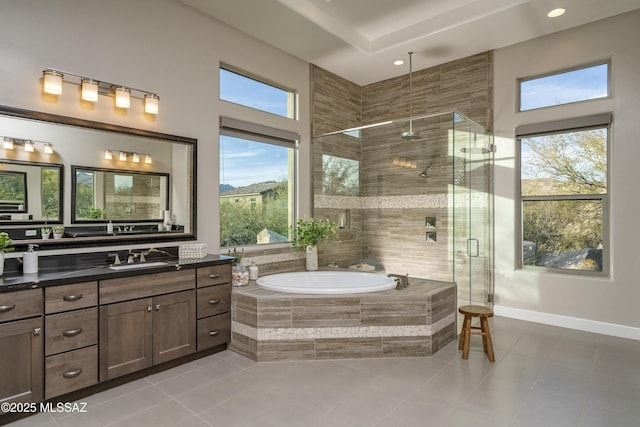 bathroom with vanity, plenty of natural light, tile patterned floors, and independent shower and bath