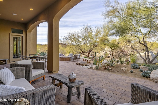 view of patio / terrace featuring an outdoor living space with a fire pit