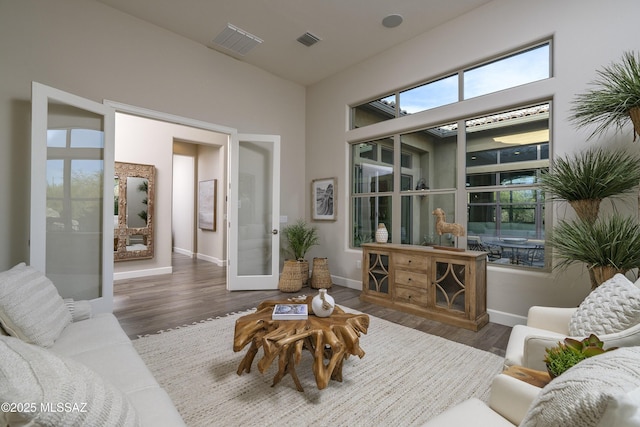 living room with dark hardwood / wood-style floors and french doors