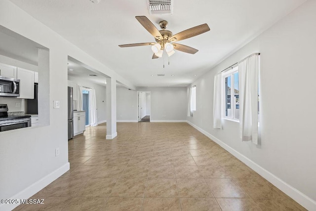 unfurnished living room featuring ceiling fan and light tile patterned floors