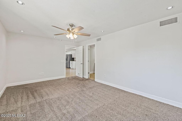 carpeted empty room with ceiling fan