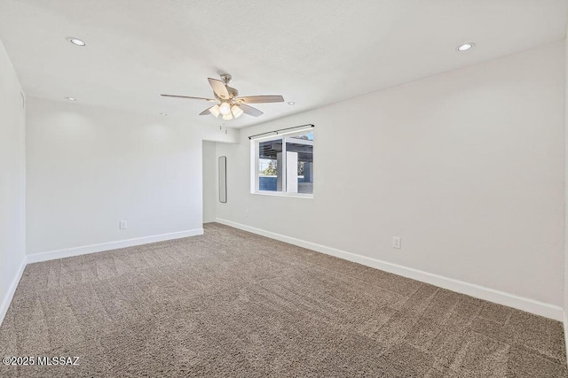 unfurnished room featuring ceiling fan and carpet floors