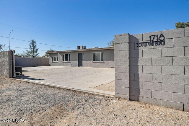 rear view of property with cooling unit and a patio area