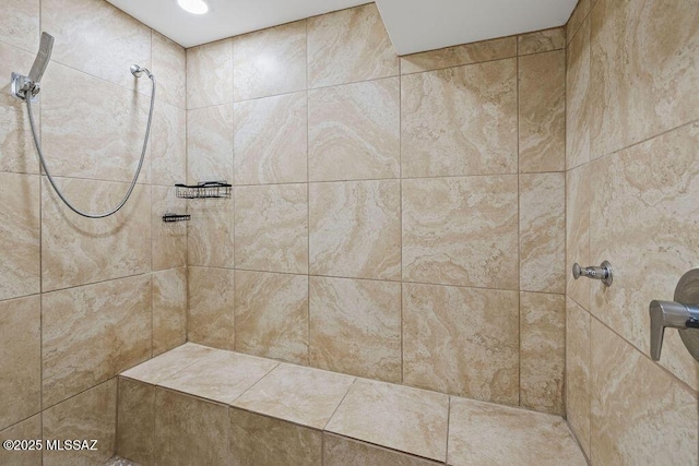 bathroom with a tile shower