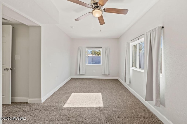 unfurnished room with ceiling fan and light carpet