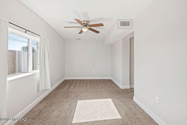 carpeted spare room with ceiling fan