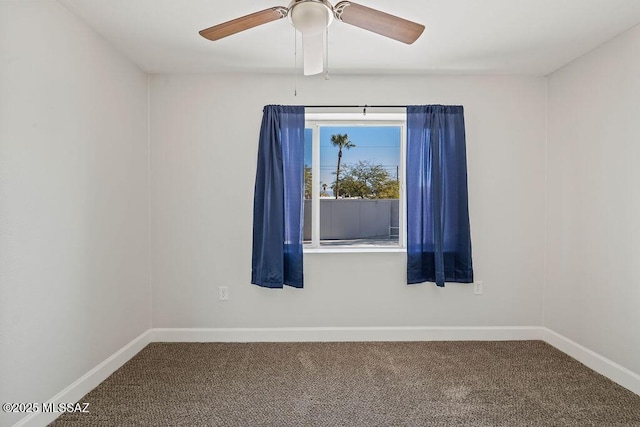 spare room featuring ceiling fan and carpet