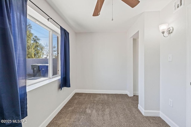 carpeted empty room featuring ceiling fan