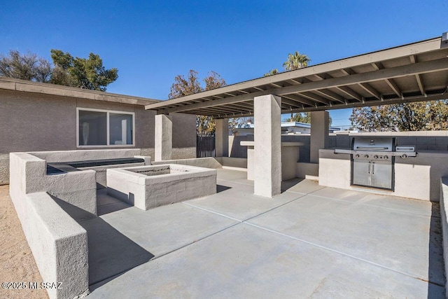 view of patio featuring an outdoor kitchen, a fire pit, and a grill