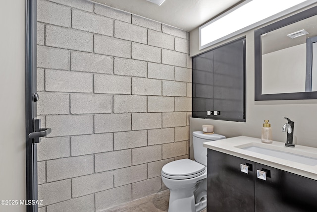 bathroom featuring toilet and vanity