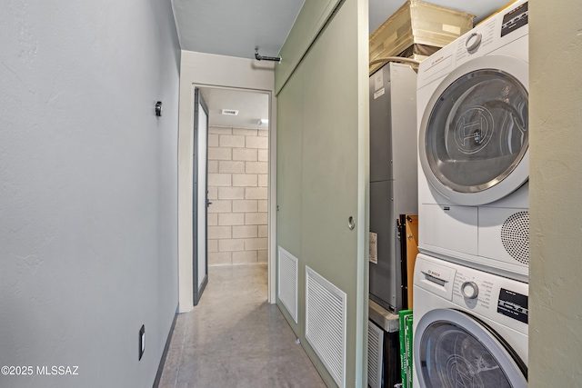 washroom featuring stacked washer / drying machine