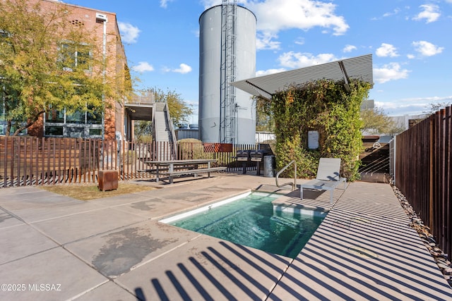 view of swimming pool featuring a patio area