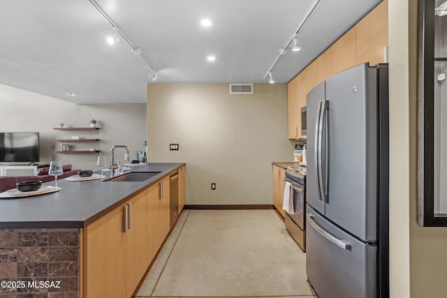 kitchen featuring kitchen peninsula, sink, light brown cabinets, and stainless steel appliances