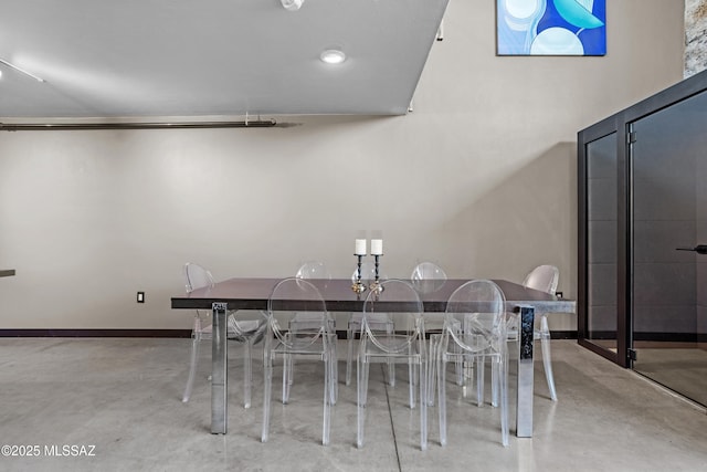 dining space with concrete flooring