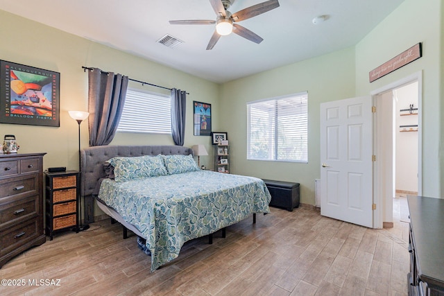 bedroom with light wood-type flooring and ceiling fan