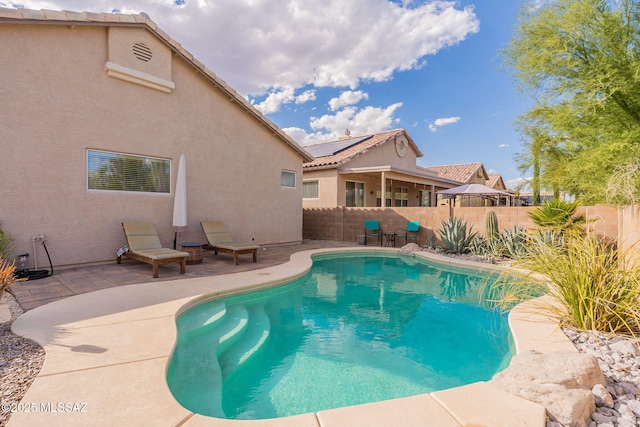 view of swimming pool with a patio area