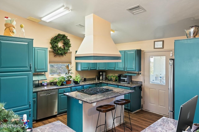 kitchen featuring blue cabinets, a center island, a kitchen breakfast bar, stainless steel dishwasher, and island range hood