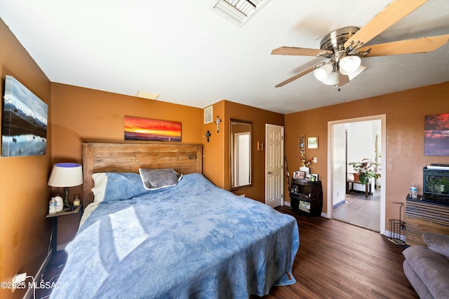 bedroom with ceiling fan and dark wood-type flooring