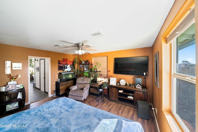 bedroom with ceiling fan and dark hardwood / wood-style floors