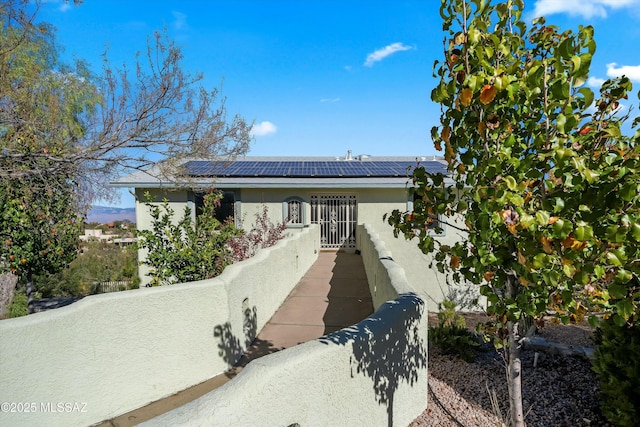 view of front of house featuring solar panels