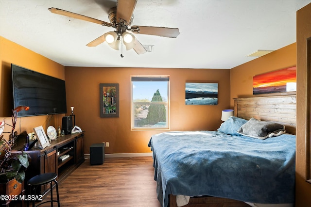 bedroom with ceiling fan and dark hardwood / wood-style flooring