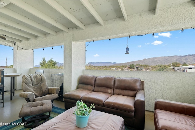 view of patio with a balcony and a mountain view