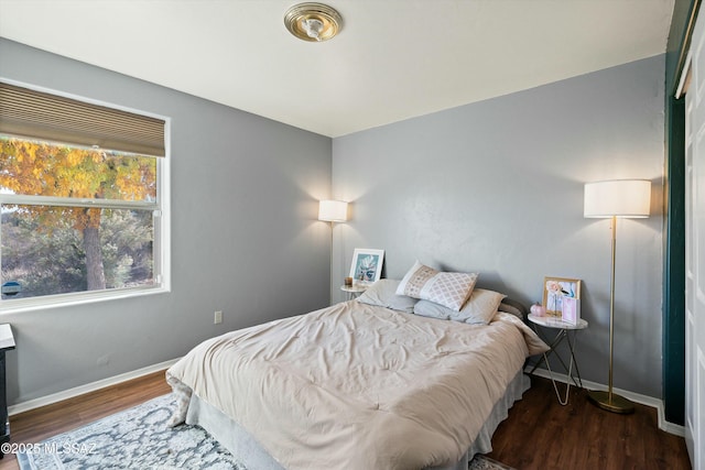 bedroom with dark wood-type flooring