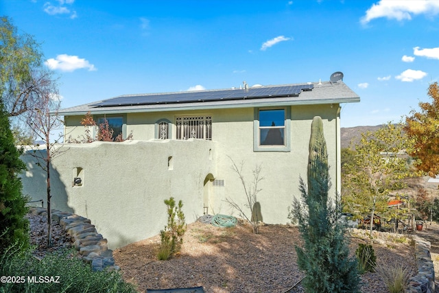 view of property exterior featuring solar panels