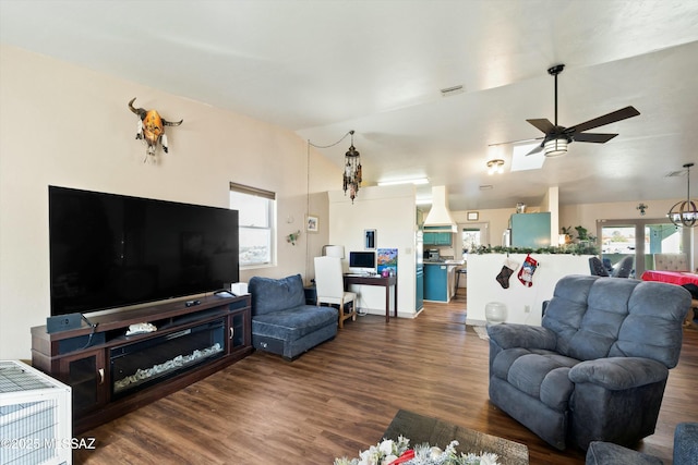 living room with lofted ceiling, ceiling fan, and dark hardwood / wood-style flooring