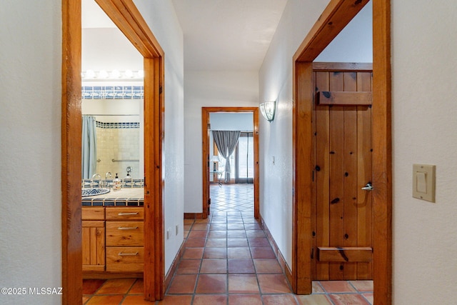 corridor with dark tile patterned floors