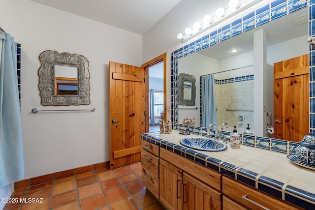 bathroom featuring curtained shower, tile patterned flooring, and vanity