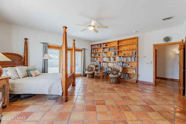 tiled bedroom featuring ceiling fan