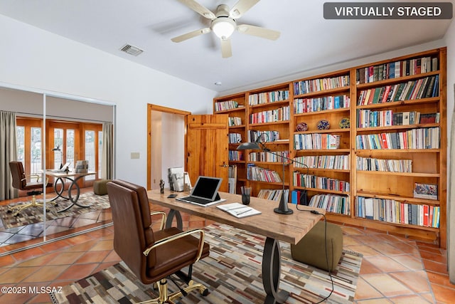 tiled office featuring ceiling fan