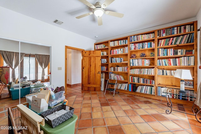 living area with tile patterned flooring and ceiling fan