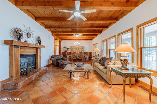 living room featuring beamed ceiling, ceiling fan, light tile patterned floors, and wood ceiling