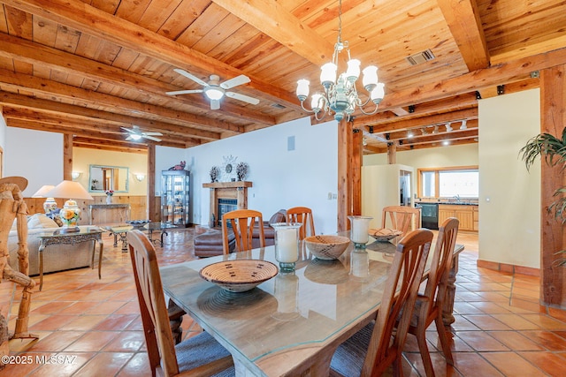 tiled dining space featuring ceiling fan with notable chandelier, wooden ceiling, and beam ceiling