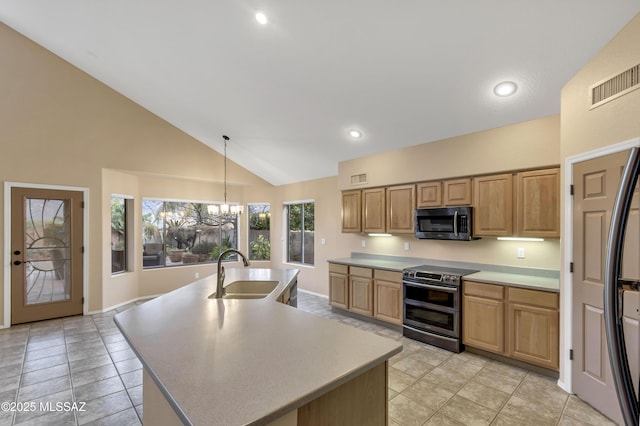 kitchen with pendant lighting, sink, a kitchen island with sink, a notable chandelier, and stainless steel appliances