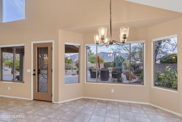 unfurnished dining area featuring light tile patterned flooring, plenty of natural light, high vaulted ceiling, and an inviting chandelier