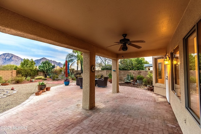 view of patio / terrace with a mountain view, an outdoor living space, and ceiling fan