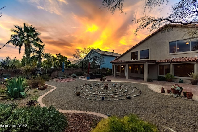 yard at dusk with a patio area