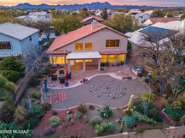 exterior space with area for grilling, an outdoor fire pit, a mountain view, and a patio