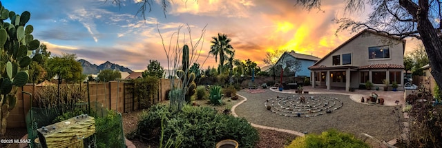 yard at dusk with a patio area