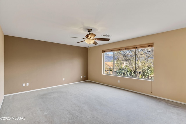 spare room with light carpet and ceiling fan