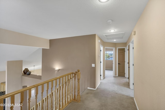 hall with light colored carpet