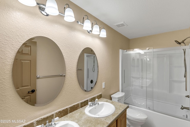 full bathroom with bath / shower combo with glass door, vanity, and toilet