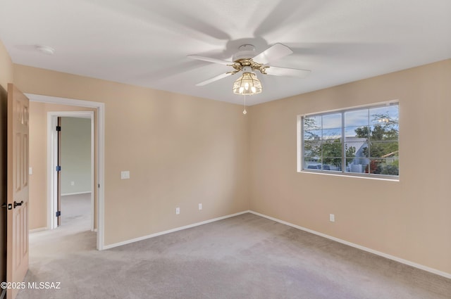 carpeted spare room with ceiling fan