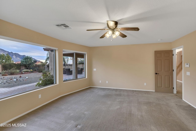 carpeted empty room featuring ceiling fan