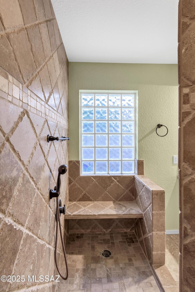 bathroom featuring a tile shower