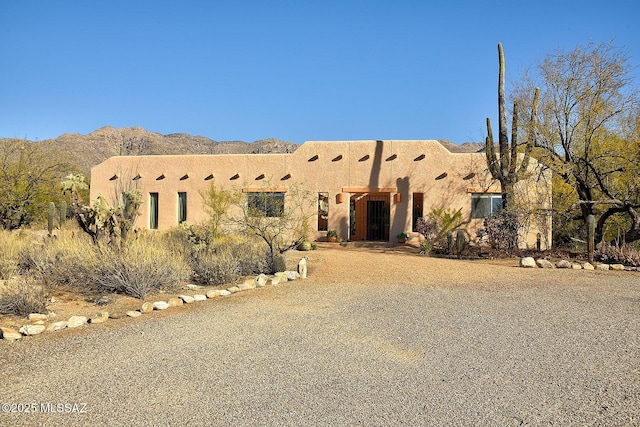 adobe home with a mountain view